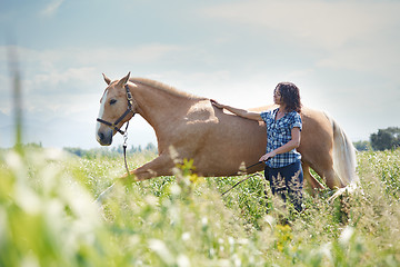 Image showing Woman training her horse