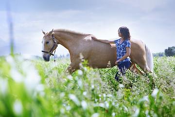 Image showing Woman training her horse