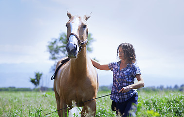 Image showing Woman training her horse