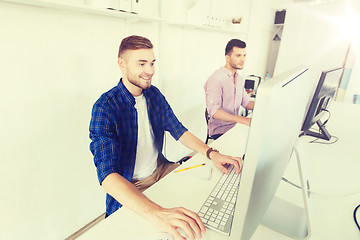 Image showing creative man or student with computer at office