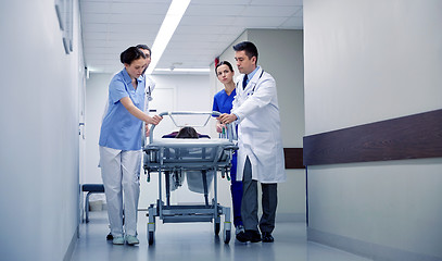 Image showing medics and patient on hospital gurney at emergency