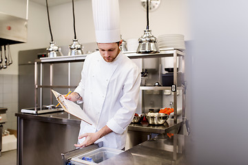 Image showing chef with clipboard doing inventory at kitchen