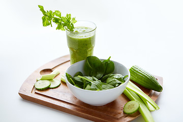 Image showing close up of glass with green juice and vegetables