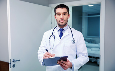 Image showing doctor with stethoscope and clipboard at hospital