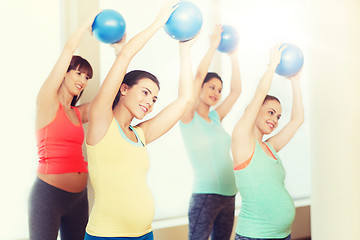 Image showing happy pregnant women exercising with ball in gym