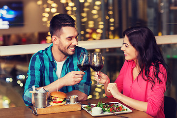 Image showing happy couple dining and drink wine at restaurant