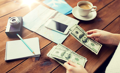 Image showing close up of traveler hands counting dollar money