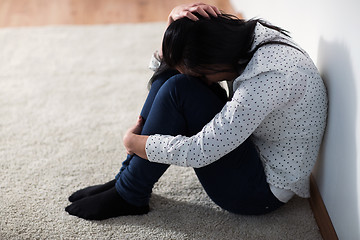 Image showing unhappy woman crying on floor at home