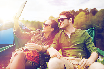 Image showing happy couple with tablet pc at camping tent