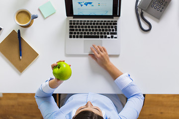 Image showing businesswoman with apple and laptop at office