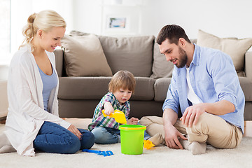 Image showing happy family playing with beach toys at home