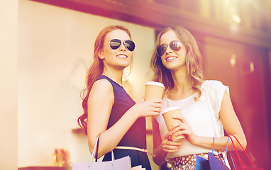 Image showing young women with shopping bags and coffee at shop