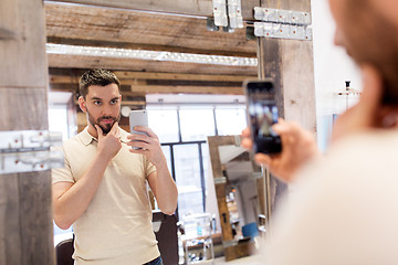 Image showing man taking selfie by smartphone at barbershop