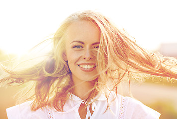 Image showing close up of happy young woman in white outdoors