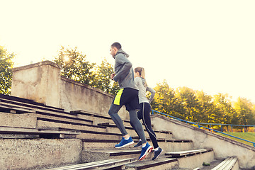 Image showing couple running upstairs on stadium