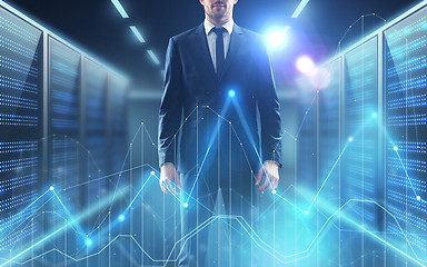 Image showing businessman with virtual diagram charts