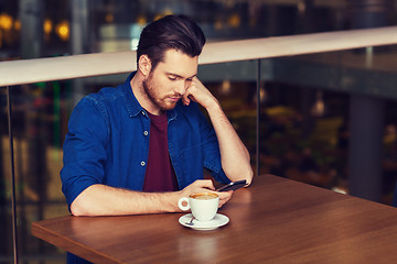 Image showing man with smartphone and coffee at restaurant