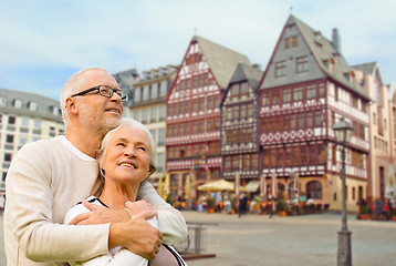 Image showing senior couple hugging over frankfurt background