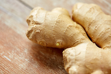 Image showing close up of ginger root on wooden table