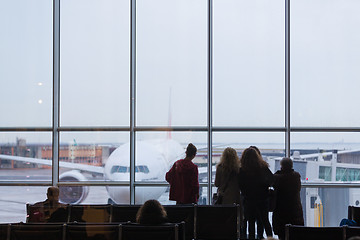 Image showing People waiting for airplane departure on a rainy day.