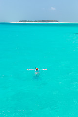 Image showing Woman snorkeling in clear shallow sea of tropical lagoon with turquoise blue water.