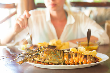 Image showing Grilled lobster served with potatoes and coconut sauce.