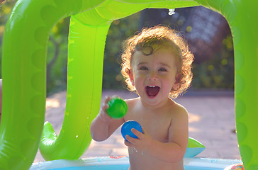 Image showing Laughing little girl play in the pool 