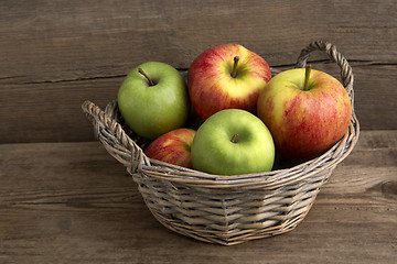 Image showing Basket of fresh apples on wooden background