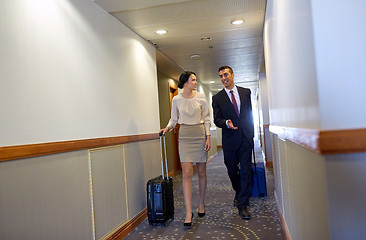 Image showing business team with travel bags at hotel corridor