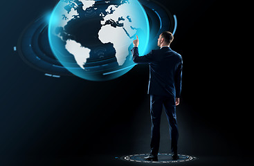 Image showing businessman in suit touching earth globe hologram