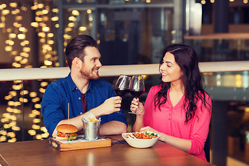 Image showing happy couple dining and drink wine at restaurant