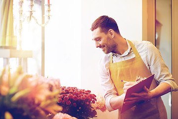 Image showing florist man with clipboard at flower shop