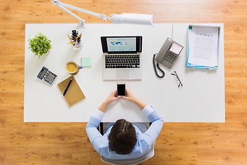 Image showing businesswoman with laptop and smartphone at office