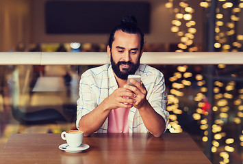 Image showing happy man with smartphone and coffee at restaurant