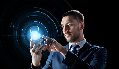 Image showing businessman with transparent smartphone