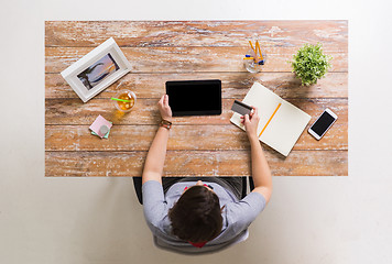 Image showing woman with tablet pc and credit card at table