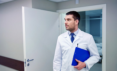 Image showing doctor with clipboard at hospital corridor