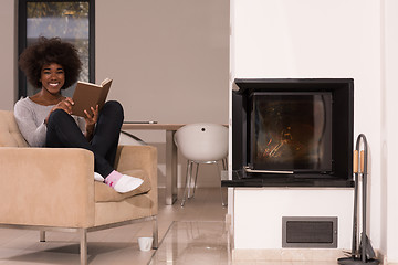 Image showing black woman at home reading book