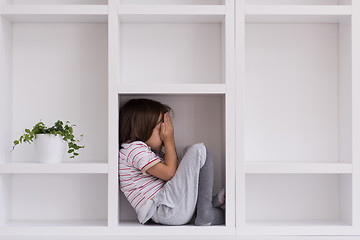 Image showing young boy posing on a shelf