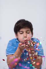 Image showing kid blowing confetti