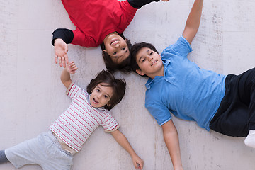 Image showing young boys having fun on the floor