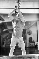 Image showing man workout with hammer and tractor tire