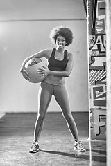 Image showing black woman carrying crossfit ball