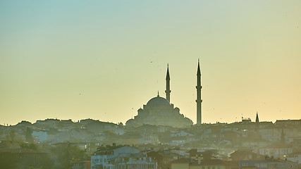 Image showing Silhouette of a Mosque Fatih in a fog and sunlight reflections. Vintage style.