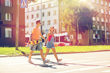 Image showing teenage couple with skateboards on city street