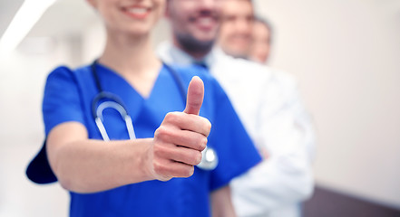 Image showing close up of doctors at hospital showing thumbs