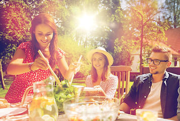 Image showing happy friends having dinner at summer garden party