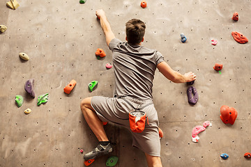 Image showing young man exercising at indoor climbing gym