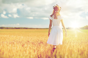 Image showing happy young woman in flower wreath on cereal field