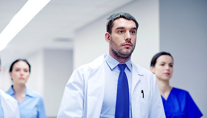 Image showing group of medics walking along hospital